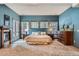 Primary bedroom featuring multiple windows, a fireplace, and carpet floors at 1662 Gore Dr, Larkspur, CO 80118