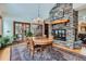 Elegant dining room featuring a stone fireplace and windows with scenic views at 1662 Gore Dr, Larkspur, CO 80118