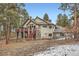 Exterior elevation showcasing the home's architecture and natural setting at 1662 Gore Dr, Larkspur, CO 80118