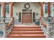 Inviting entryway with a solid wood door, stone pillars, and decorative wall lanterns creating a warm ambiance at 1662 Gore Dr, Larkspur, CO 80118