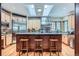 Bright kitchen with stainless steel appliances, granite countertops, island with seating, and natural light from skylights at 1662 Gore Dr, Larkspur, CO 80118