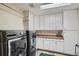 Spacious laundry room featuring updated appliances and white cabinets at 1662 Gore Dr, Larkspur, CO 80118