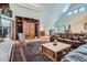 Spacious living room featuring a built-in wooden entertainment center and comfortable leather sofa at 1662 Gore Dr, Larkspur, CO 80118