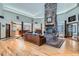 Expansive living room featuring a floor-to-ceiling stone fireplace, hardwood floors, and an open layout for entertaining at 1662 Gore Dr, Larkspur, CO 80118
