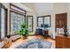 Bright home office with large windows, a modern desk setup, and natural lighting at 1662 Gore Dr, Larkspur, CO 80118
