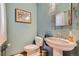 Charming powder room featuring a pedestal sink, stylish mirror, and fresh decor at 1662 Gore Dr, Larkspur, CO 80118