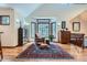 Cozy sitting room featuring large windows, hardwood floors, and comfortable seating at 1662 Gore Dr, Larkspur, CO 80118