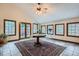 Sun-filled room featuring tiled floors, large windows, and a table for relaxation at 1662 Gore Dr, Larkspur, CO 80118