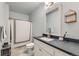 Bathroom features modern vanity with gray counters, modern fixtures, and tiled floors at 6320 Indian Paintbrush St # 108, Frederick, CO 80530