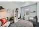 Bedroom featuring large mirror, office setup, accent chair, bookshelf, and large window at 6320 Indian Paintbrush St # 108, Frederick, CO 80530