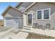 Charming single-story home with a two-car garage, cozy front porch with seating, and well-maintained lawn at 6320 Indian Paintbrush St # 108, Frederick, CO 80530
