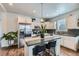 Well-lit kitchen featuring stainless steel appliances, black countertops and modern backsplash at 6320 Indian Paintbrush St # 108, Frederick, CO 80530