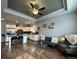 Open concept living room with hardwood floors, modern furniture, and adjacent kitchen area at 6320 Indian Paintbrush St # 108, Frederick, CO 80530