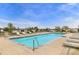 A sparkling community pool surrounded by lounge chairs offering a relaxing outdoor space at 6320 Indian Paintbrush St # 108, Frederick, CO 80530