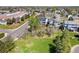 Aerial view features a home with a spacious lot, solar panels, and proximity to a green area, and local amenities at 9684 W Long Dr, Littleton, CO 80123