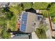 Overhead view of a well-maintained home with solar panels, a lush lawn, fire pit, and play set at 9684 W Long Dr, Littleton, CO 80123