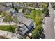 Aerial view reveals a beautiful home with a backyard, solar panels, mature trees, and a tranquil neighborhood setting at 9684 W Long Dr, Littleton, CO 80123