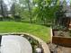 Lush backyard showcasing a garden area, vibrant green lawn, and mature trees, creating a tranquil outdoor space at 9684 W Long Dr, Littleton, CO 80123