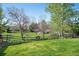 Spacious, grassy backyard with a wooden fence and mature trees, creating a peaceful and private outdoor space at 9684 W Long Dr, Littleton, CO 80123