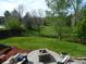 Spacious backyard featuring a fire pit, lush lawn, and well-maintained landscaping, ideal for outdoor entertaining at 9684 W Long Dr, Littleton, CO 80123