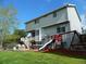 Picturesque backyard featuring a lush lawn, playset, patio with seating, and a second story deck at 9684 W Long Dr, Littleton, CO 80123