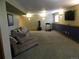 Basement with sectional sofa, treadmill, punching bag, and a TV at 9684 W Long Dr, Littleton, CO 80123