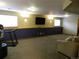 Finished basement with exercise equipment, TV, neutral paint and trim at 9684 W Long Dr, Littleton, CO 80123