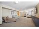 Finished basement with plush carpeting, neutral paint, and comfortable seating, ideal for relaxation and recreation at 9684 W Long Dr, Littleton, CO 80123