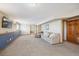 Finished basement featuring neutral colors, plush carpet, and ample open space, ready for flexible use at 9684 W Long Dr, Littleton, CO 80123