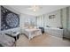 Well-lit bedroom with decorative tapestry, ceiling fan and window view at 9684 W Long Dr, Littleton, CO 80123