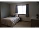 Calming bedroom featuring a bed by a window, a neutral wall, and plush carpet at 9684 W Long Dr, Littleton, CO 80123