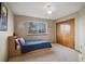Bedroom with neutral colored carpet, natural lighting and light wooden closet doors at 9684 W Long Dr, Littleton, CO 80123