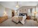 Spacious primary bedroom with vaulted ceilings, a luxurious bed, and an ensuite bathroom at 9684 W Long Dr, Littleton, CO 80123
