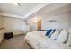 Cozy bedroom with comfortable bed, neutral walls, and carpet flooring, designed for relaxation and rest at 9684 W Long Dr, Littleton, CO 80123