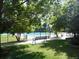 Serene community pool with bench surrounded by green lawns and shade trees at 9684 W Long Dr, Littleton, CO 80123