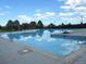 Large community pool with clear blue water, diving boards, and lifeguard chairs at 9684 W Long Dr, Littleton, CO 80123