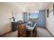 Elegant dining room with tray ceiling, chandelier, and natural light at 9684 W Long Dr, Littleton, CO 80123