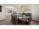 Elegant dining room featuring a chandelier, a large window, and a view into living room at 9684 W Long Dr, Littleton, CO 80123