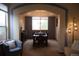 Elegant dining room featuring a chandelier, large window, and a formal dining table set for a meal at 9684 W Long Dr, Littleton, CO 80123