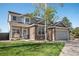 Charming two-story home with stone accents, manicured lawn, and a welcoming front porch at 9684 W Long Dr, Littleton, CO 80123