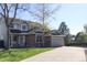 Charming two-story home with stone accents, a two-car garage, and a long driveway at 9684 W Long Dr, Littleton, CO 80123