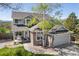 Beautiful home featuring stone accents, attached two-car garage, manicured lawn, and mature trees at 9684 W Long Dr, Littleton, CO 80123