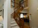 Elegant foyer with a staircase featuring wooden railings and a view of the living room at 9684 W Long Dr, Littleton, CO 80123