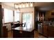 Modern kitchen featuring a center island, stainless steel appliances, and an adjacent breakfast nook at 9684 W Long Dr, Littleton, CO 80123