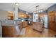 Well-lit kitchen featuring a center island, stainless steel appliances and wooden cabinets at 9684 W Long Dr, Littleton, CO 80123