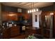 Well-equipped kitchen with wood cabinets, granite countertops, stainless steel appliances, and modern lighting at 9684 W Long Dr, Littleton, CO 80123