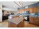 Spacious kitchen with granite counters, stainless appliances, and ample cabinet space at 9684 W Long Dr, Littleton, CO 80123