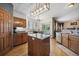 Open kitchen with center island, stainless steel appliances, and hardwood floors at 9684 W Long Dr, Littleton, CO 80123