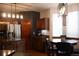 Bright kitchen with stainless steel refrigerator, granite countertops, a breakfast nook, and modern lighting at 9684 W Long Dr, Littleton, CO 80123