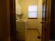 Well-lit laundry room features a washer, dryer, and storage cabinets at 9684 W Long Dr, Littleton, CO 80123